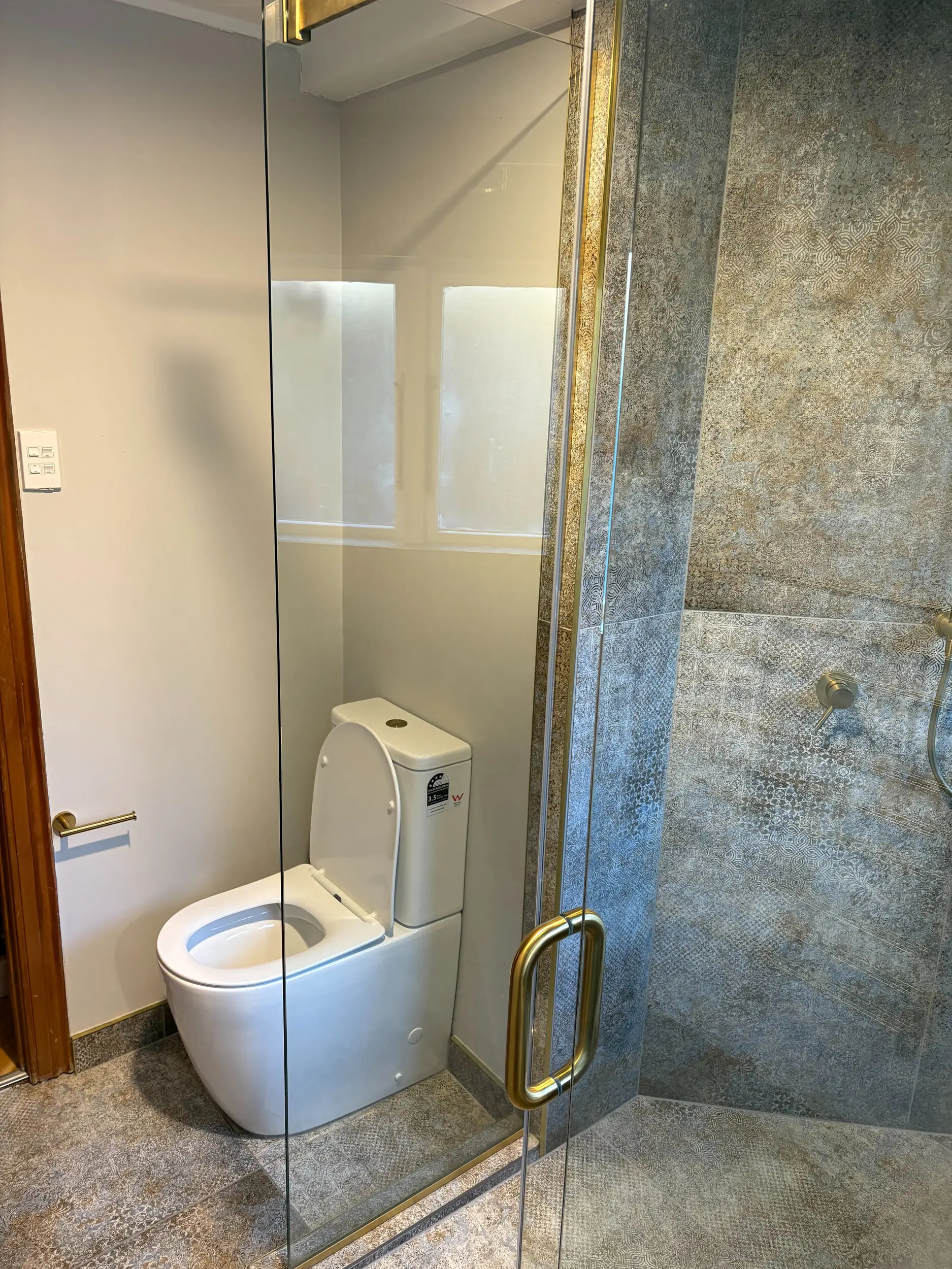 Finished tiled bathroom with walk-in shower and floating vanity