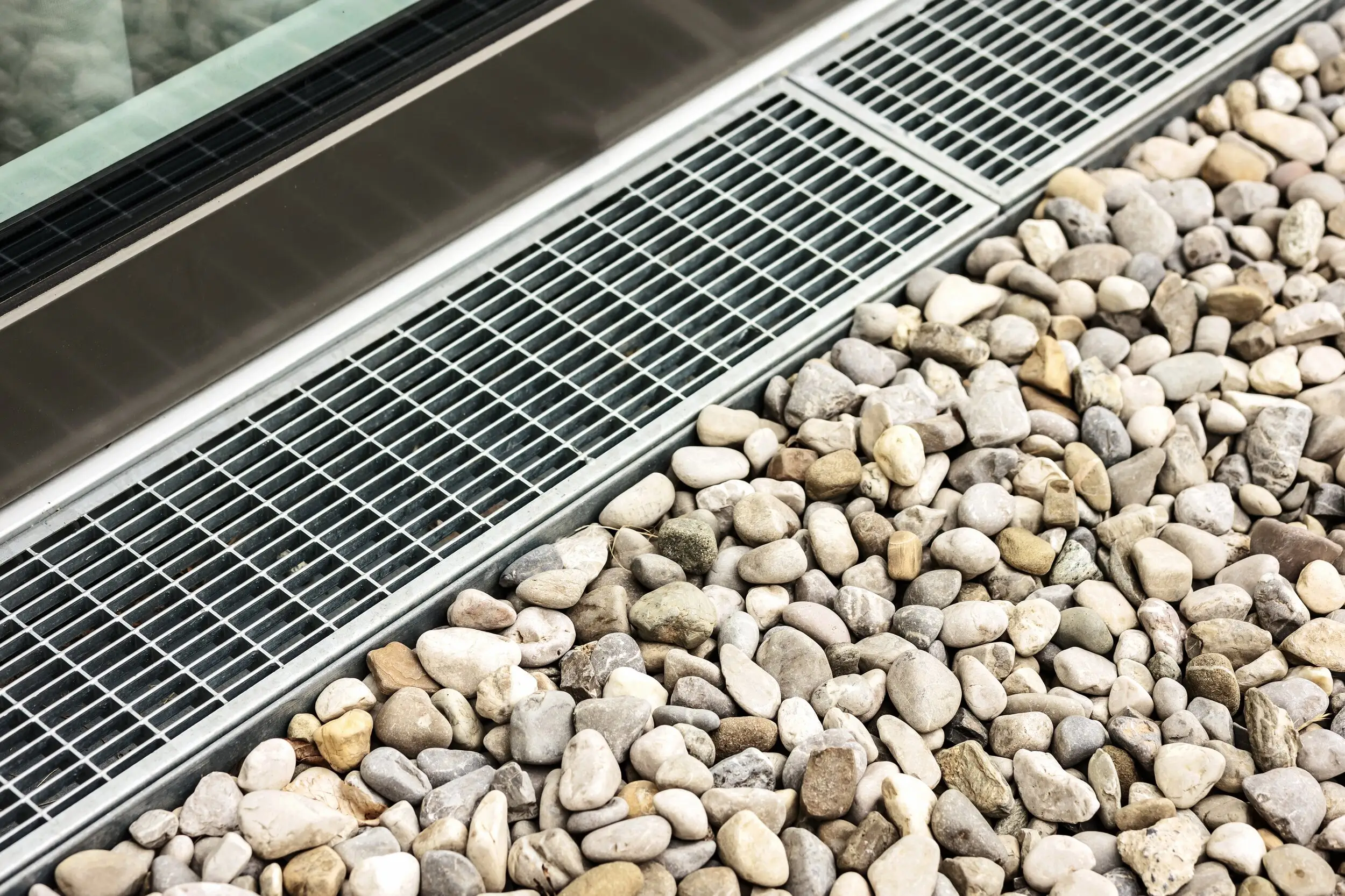 New channel drain grate set into a gravel path