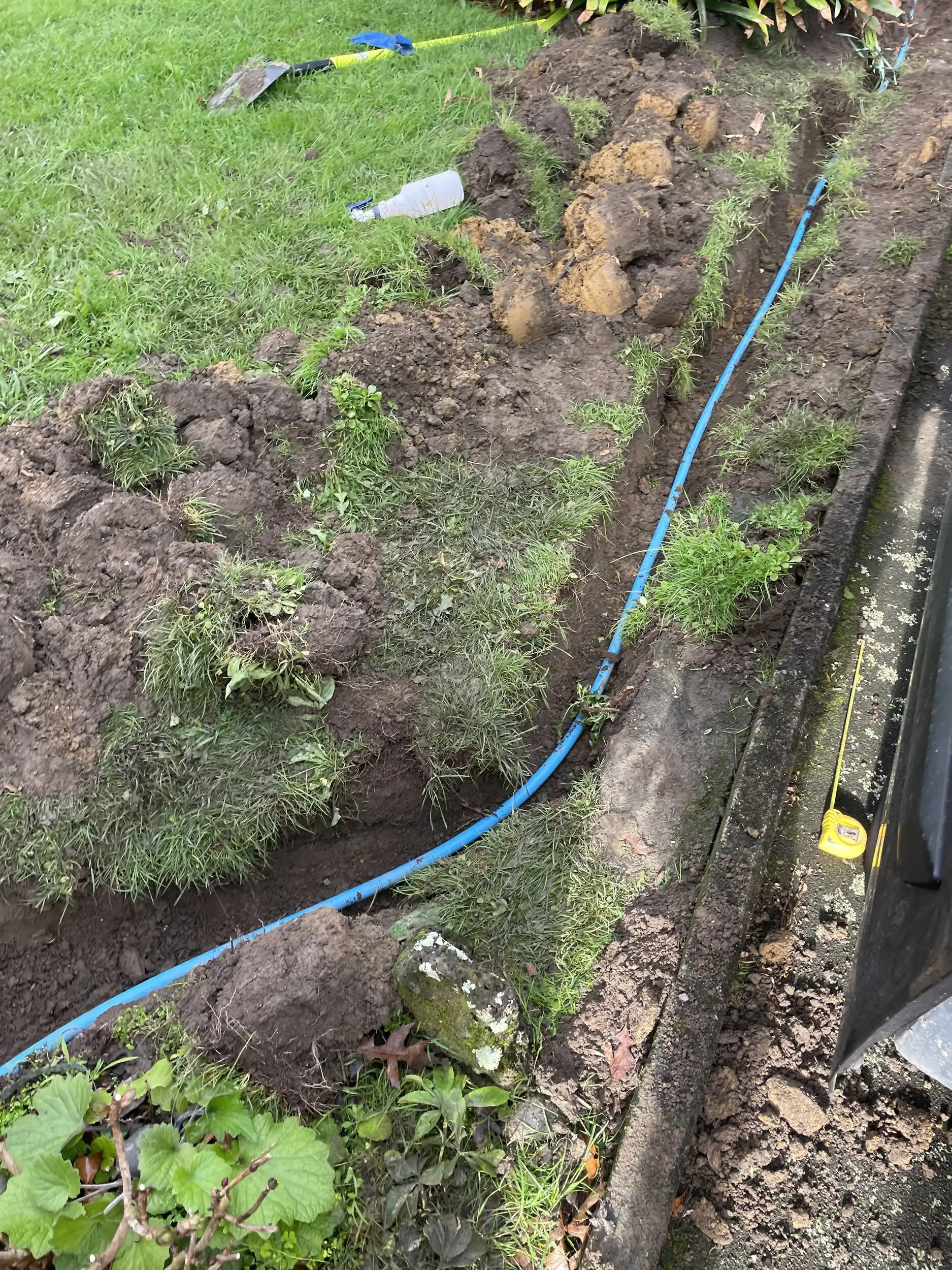 New drainage laid in a trench across a lawn