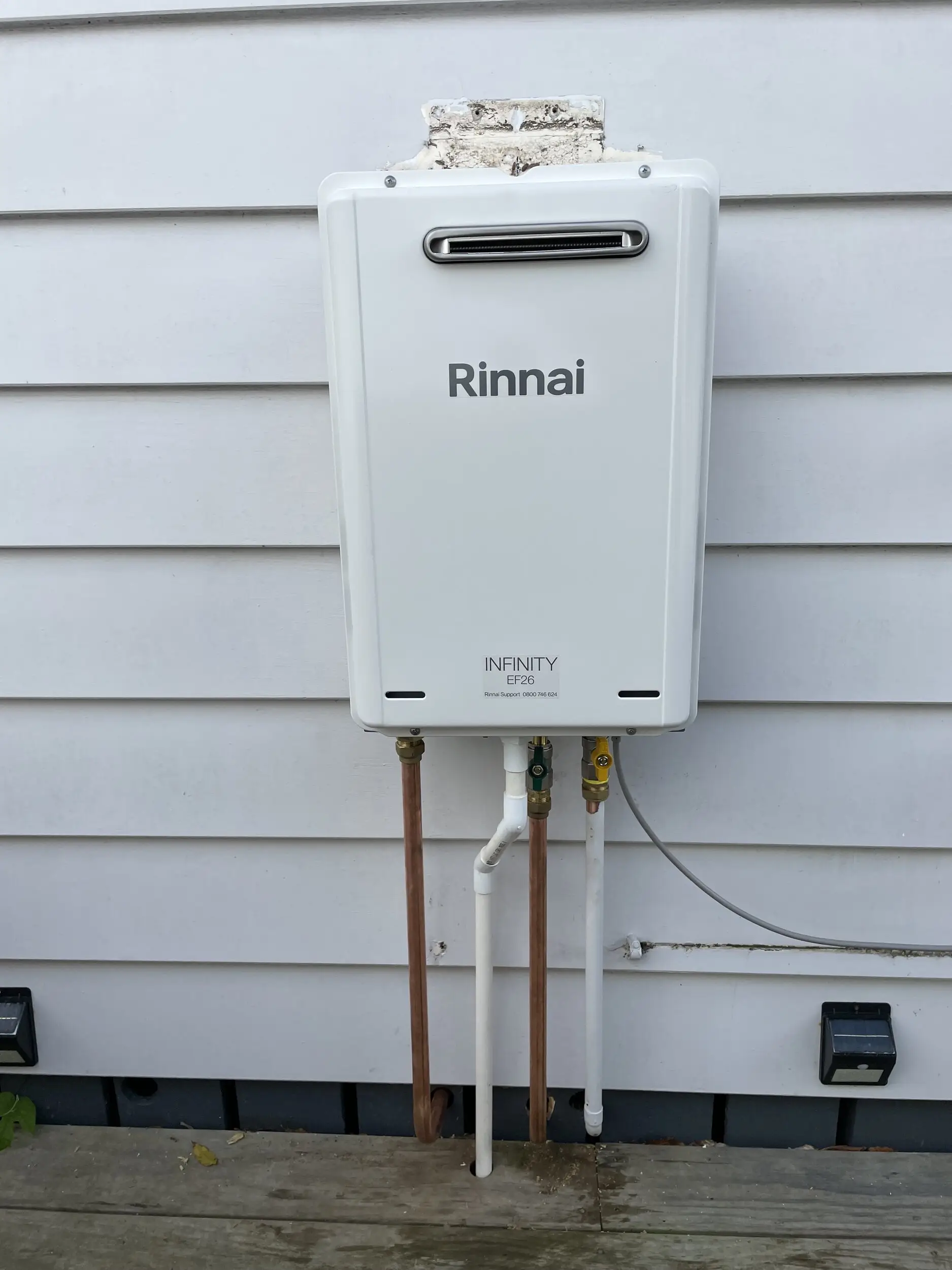 Rinnai continuous flow gas hot water unit on an exterior wall